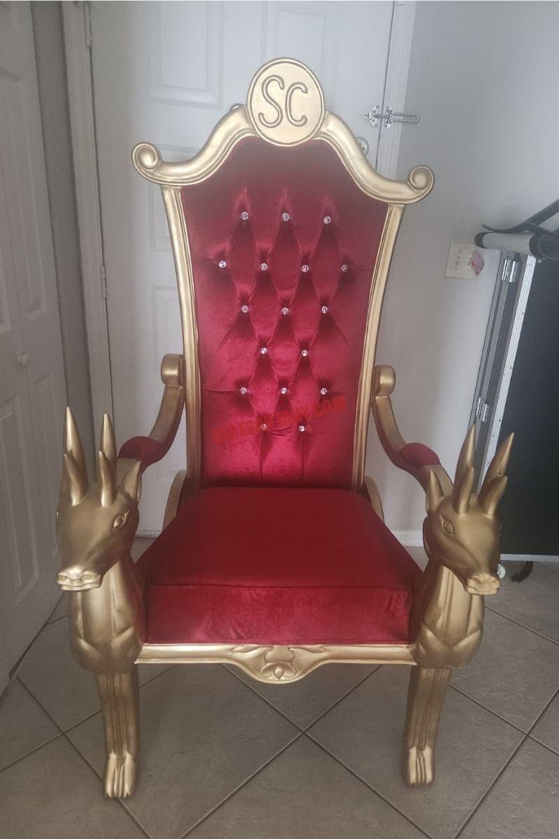Santa chair photos: empty gold frame and red tufted back on indoor tile, no Santa in the seat