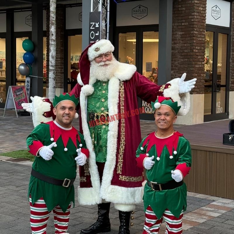 Contact Hire Santa NY: Santa impersonator standing with two elves, ready to book